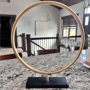 Gold Metal Circular Sculpture on Black Base